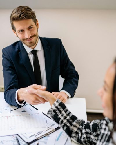 pexels-photo-7693157-7693157 A Smiling Man Shaking Hands with a Person at an Office